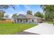 Charming, newly built single-Gathering home featuring a covered front porch, and long driveway at 349 Baker Ave, Lake Helen, FL 32744
