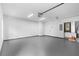 Spacious, well-lit garage with a smooth epoxy floor and overhead lighting fixtures at 349 Baker Ave, Lake Helen, FL 32744