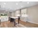 Modern kitchen with white cabinets, stainless steel appliances, kitchen island, and hardwood floors at 349 Baker Ave, Lake Helen, FL 32744