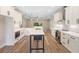 Bright, modern kitchen features an island, white cabinetry and stainless steel appliances at 349 Baker Ave, Lake Helen, FL 32744
