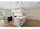 Bright kitchen boasts stainless steel appliances, white cabinetry and quartz countertops at 349 Baker Ave, Lake Helen, FL 32744