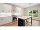 Bright kitchen with stainless steel appliances, white cabinetry and a kitchen island at 349 Baker Ave, Lake Helen, FL 32744