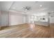 Spacious living room with wood-look flooring, a trey ceiling and modern ceiling fan at 349 Baker Ave, Lake Helen, FL 32744