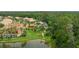 Aerial view of home near a pond, pool, and lush landscaping at 3592 Grande Tuscany Way, New Smyrna Beach, FL 32168