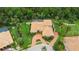 Aerial view of the property featuring mature landscaping, lush lawn, swimming pool, and tiled roof at 3592 Grande Tuscany Way, New Smyrna Beach, FL 32168