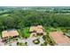 Beautiful aerial view of luxury home featuring a circular driveway, fountain, lush landscaping, and large trees at 3592 Grande Tuscany Way, New Smyrna Beach, FL 32168