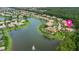 Expansive aerial view showcasing waterfront homes in a vibrant community with well-maintained landscaping and a large lake at 3592 Grande Tuscany Way, New Smyrna Beach, FL 32168