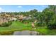 Lush backyard featuring well-maintained landscaping and a serene pond at 3592 Grande Tuscany Way, New Smyrna Beach, FL 32168