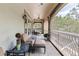 Inviting covered balcony features tile floors, a ceiling fan, and views of the lush greenery at 3592 Grande Tuscany Way, New Smyrna Beach, FL 32168