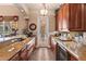 Elegant bar area featuring granite countertops, custom cabinetry, and a wine refrigerator at 3592 Grande Tuscany Way, New Smyrna Beach, FL 32168