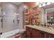 A bathroom offering a shower, vanity with framed art, decorative vase, and warm wall color at 3592 Grande Tuscany Way, New Smyrna Beach, FL 32168