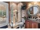 Elegant bathroom with glass shower, custom mirror, and tasteful decor with natural light at 3592 Grande Tuscany Way, New Smyrna Beach, FL 32168