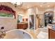 Spacious bathroom featuring a soaking tub, dual vanity, and elegant decor at 3592 Grande Tuscany Way, New Smyrna Beach, FL 32168