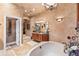Elegant bathroom showcasing a soaking tub, custom vanity, and designer finishes at 3592 Grande Tuscany Way, New Smyrna Beach, FL 32168