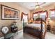 Charming bedroom featuring a four-poster bed, decorative accents, and natural light at 3592 Grande Tuscany Way, New Smyrna Beach, FL 32168