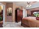 Bedroom with a large bed, a wood armoire and decorative niche at 3592 Grande Tuscany Way, New Smyrna Beach, FL 32168