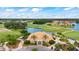 Stunning overhead shot of the clubhouse near the golf course with lush greenery creating an inviting community hub at 3592 Grande Tuscany Way, New Smyrna Beach, FL 32168