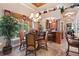 Cozy dining area with a chandelier, large windows, and a built-in bar with seating at 3592 Grande Tuscany Way, New Smyrna Beach, FL 32168