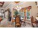 Bright dining area with chandelier, large windows overlooking the pool and backyard at 3592 Grande Tuscany Way, New Smyrna Beach, FL 32168