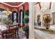 Formal dining room with elegant chandelier, rich red walls, and view into entry and hall at 3592 Grande Tuscany Way, New Smyrna Beach, FL 32168