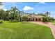 Beautiful house with a large green lawn, brick driveway, and well-manicured landscaping at 3592 Grande Tuscany Way, New Smyrna Beach, FL 32168