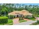 Gorgeous exterior showcasing mature landscaping, brick driveway, and lush green lawn at 3592 Grande Tuscany Way, New Smyrna Beach, FL 32168