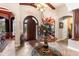 Elegant foyer features wood accents, decorative flooring and a grand floral arrangement at 3592 Grande Tuscany Way, New Smyrna Beach, FL 32168