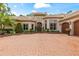 Stunning front exterior features a brick driveway, manicured landscaping, and a grand entrance at 3592 Grande Tuscany Way, New Smyrna Beach, FL 32168