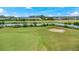 Picturesque golf course features lush greens, a sand trap, and a flag, offering a premium recreational experience at 3592 Grande Tuscany Way, New Smyrna Beach, FL 32168