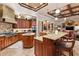 Spacious kitchen with wood cabinets, granite countertops, stainless steel appliances, and open layout at 3592 Grande Tuscany Way, New Smyrna Beach, FL 32168