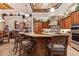 Spacious kitchen featuring an island with granite countertops, custom cabinets, and stainless steel appliances at 3592 Grande Tuscany Way, New Smyrna Beach, FL 32168