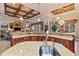 Open-concept kitchen with granite countertops, custom cabinetry, and stainless steel appliances at 3592 Grande Tuscany Way, New Smyrna Beach, FL 32168