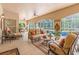 This covered patio features comfortable seating and a view of the pool at 3592 Grande Tuscany Way, New Smyrna Beach, FL 32168
