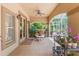 Covered patio featuring tile flooring, ceiling fans, and access to the outdoors at 3592 Grande Tuscany Way, New Smyrna Beach, FL 32168