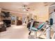 Large recreation room featuring exercise equipment, TV, and access to other rooms at 3592 Grande Tuscany Way, New Smyrna Beach, FL 32168