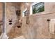 Tiled shower with dual showerheads, built-in bench, and decorative accents at 3592 Grande Tuscany Way, New Smyrna Beach, FL 32168