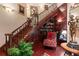 Detailed staircase with wood steps, iron railings, and a cozy reading nook with bookshelves at 3592 Grande Tuscany Way, New Smyrna Beach, FL 32168