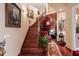 Elegant staircase with rich wood paneling, iron railings, and art displayed throughout at 3592 Grande Tuscany Way, New Smyrna Beach, FL 32168