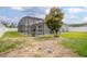 Expansive backyard with a pool and screened enclosure, offering ample space for relaxation at 413 Last Tree Dr, Deland, FL 32720