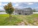 Spacious backyard featuring a pool, screened enclosure, and meticulously maintained lawn at 413 Last Tree Dr, Deland, FL 32720