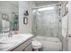 Well-lit bathroom featuring a tiled shower and tub, a single vanity, and modern fixtures at 413 Last Tree Dr, Deland, FL 32720