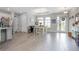 Bright dining area showcasing wood-look tile floors and an adjacent kitchen at 413 Last Tree Dr, Deland, FL 32720