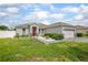 Beautiful single-Gathering home with a manicured lawn, driveway, and inviting exterior design at 413 Last Tree Dr, Deland, FL 32720