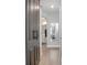 Inviting hallway with wood-look tile, leading to a stylish bathroom, and featuring a modern barn door at 413 Last Tree Dr, Deland, FL 32720