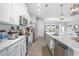 Stylish kitchen featuring marble countertops, stainless steel appliances, and bright cabinetry at 413 Last Tree Dr, Deland, FL 32720
