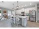 Modern kitchen with stainless steel appliances, marble countertops, and an eat-in island at 413 Last Tree Dr, Deland, FL 32720