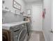Well-organized laundry room with modern appliances, shelving, and farmhouse-style decor at 413 Last Tree Dr, Deland, FL 32720