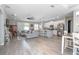 Spacious open-concept living area with modern furnishings and wood tile flooring at 413 Last Tree Dr, Deland, FL 32720