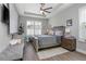 Cozy main bedroom with tray ceiling, wood floors, and a comfortable seating area at 413 Last Tree Dr, Deland, FL 32720
