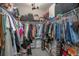 Well-organized walk-in closet with ample hanging space, shelving, and storage drawers for clothing and accessories at 413 Last Tree Dr, Deland, FL 32720